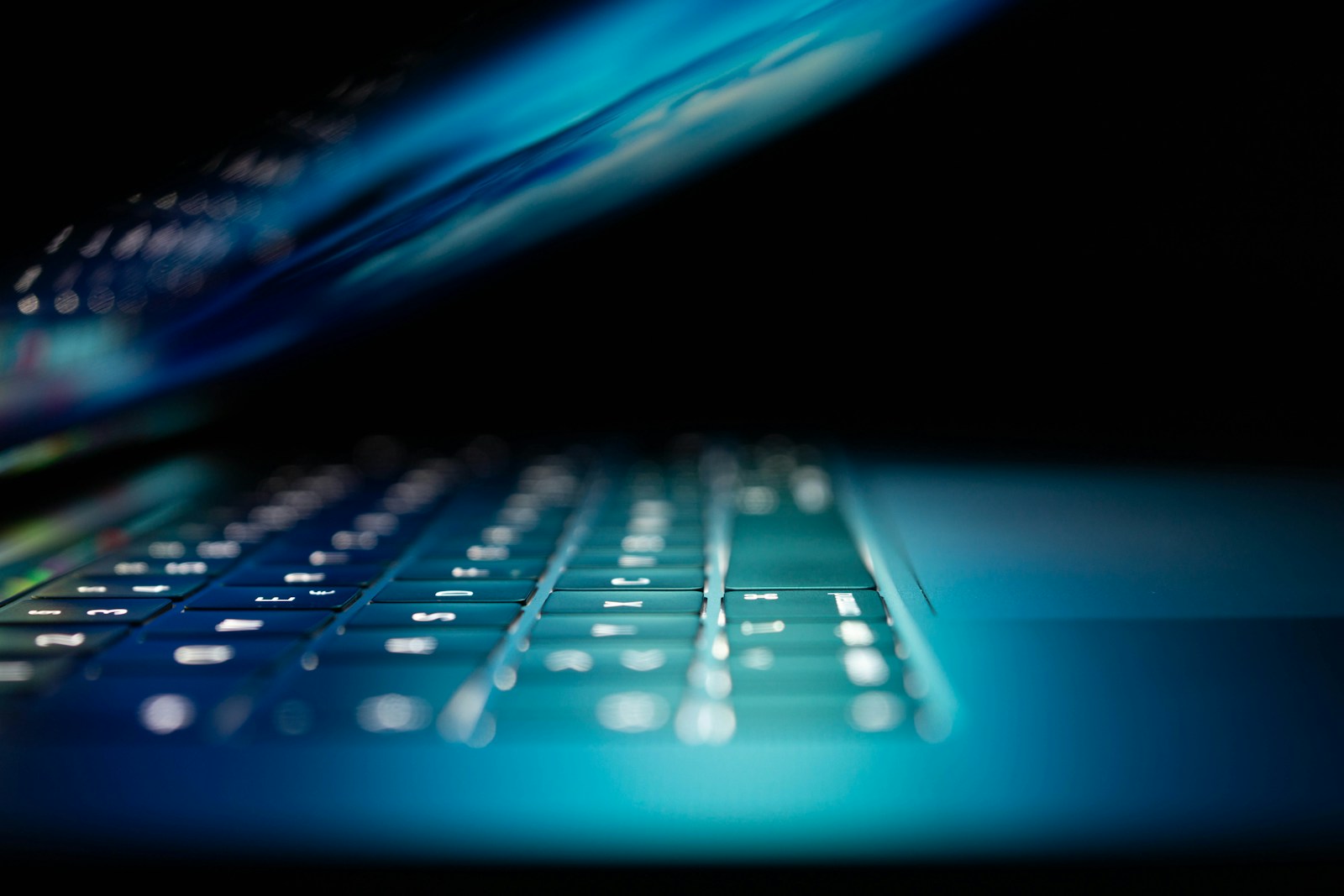 closeup photo of turned-on blue and white laptop computer symbolizing Information Security and Privacy Insurance