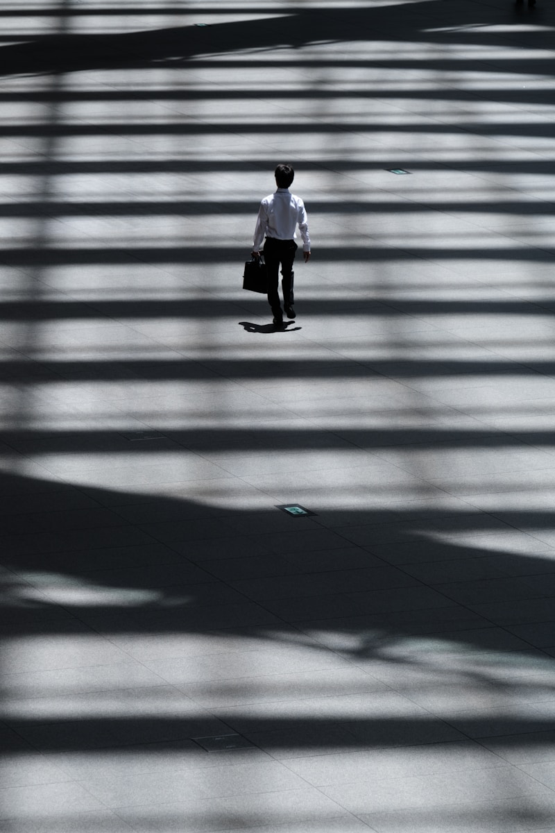 man holding laptop bag walking on street symbolizing key person life insurance